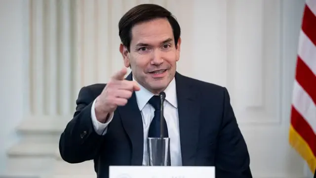 Marco Rubio in suit pointing finger at the camera