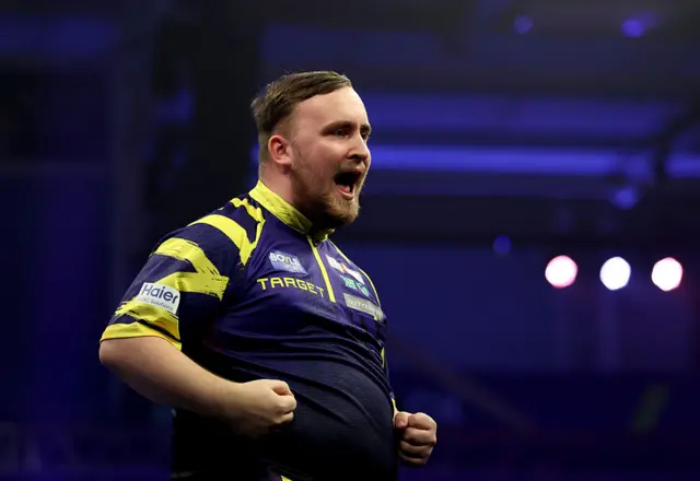 Luke Littler celebrates during his win over Gian van Veen