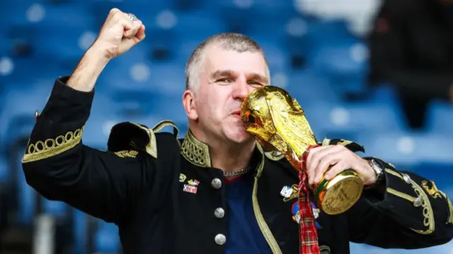 Scotland fan with world cup trophy