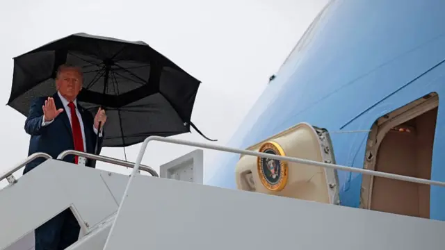 U.S. President Donald Trump waves as he boards Air Force One for a trip to the Middle East