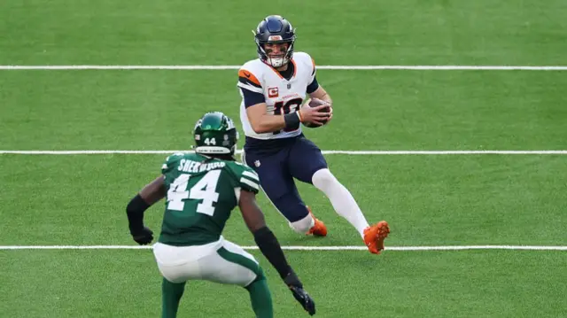 Bo Nix slides for a first down for the Denver Broncos against the New York Jets