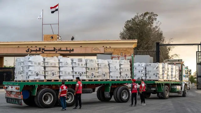 Trucks carrying aid enter Gaza through the border crossing on October 12, 2025 in Rafah, Egypt. This week's ceasefire deal between Israel and Hamas has brought an end to the two years of war that followed the attacks of Oct. 7, 2023, allowing aid groups to increase delivery of humanitarian relief.