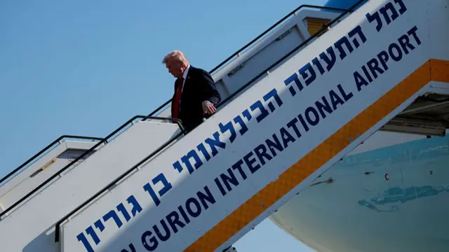Donald Trump walks down the steps as he disembarks his plane at Ben Gurion Airport
