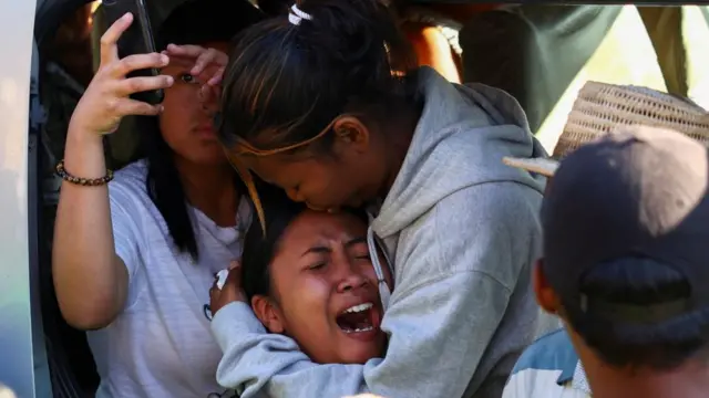 A relative of Safidy Rakooarisoa, who the family members say died during demonstrations, reacts as his body is brought to a gathering of demonstrators outside the town hall on Independence Avenue for prayers, during a nationwide youth-led protest over persistent power outages and water shortages, in Antananarivo, Madagascar, October 13, 2025.