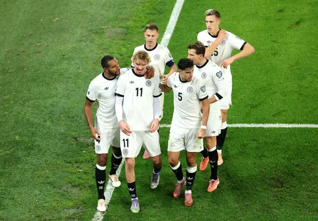 Nick Woltemade of Germany celebrates with his teammates after scoring his team's first goal