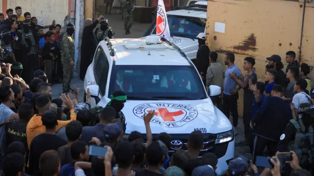 Red Cross vehicles transport hostages, held in Gaza since the deadly October 7, 2023 attack
