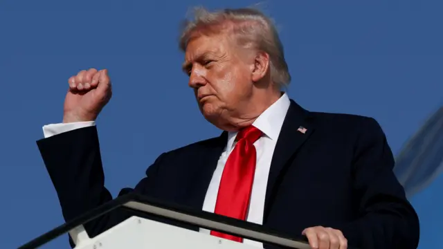 Trump gestures as he boards Air Force One en route to Sharm El-Sheikh