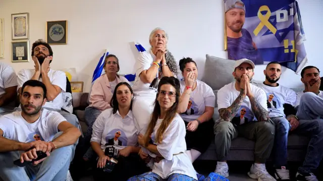 All wearing tshirts with his face looking anxious