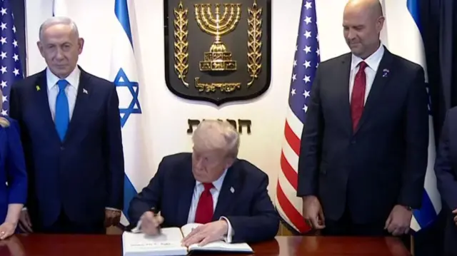 Trump signs book in Knesset before speech