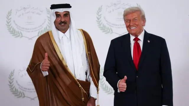 Emir of Qatar Sheikh Tamim bin Hamad Al Thani and US President Donald Trump  stood side by side with thumbs up, smiling.