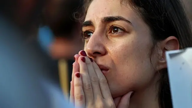 A woman reacts in Hostages Sqaure