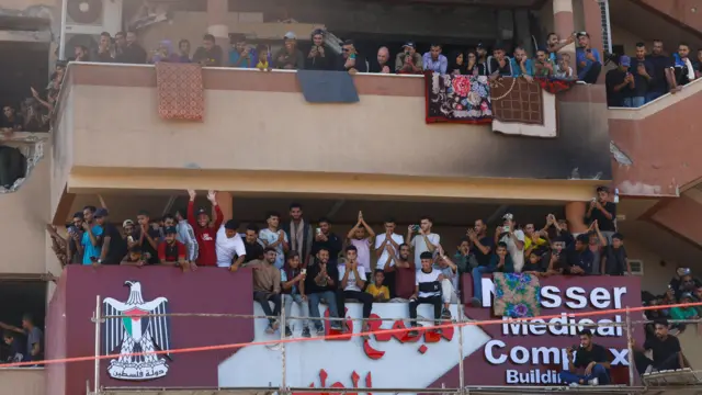 People react at a building in Nasser hospital as they welcome freed Palestinian prisoners