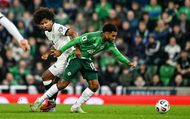 Jamie Reid of Northern Ireland in action against Karim Adeyemi of Germany