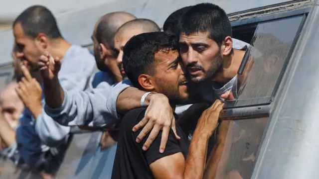 A man greets a freed Palestinian prisoner released by Israel as part of a hostages-prisoners swap