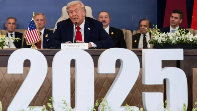 Trump speaks during the official signing ceremony, flanked by world leaders