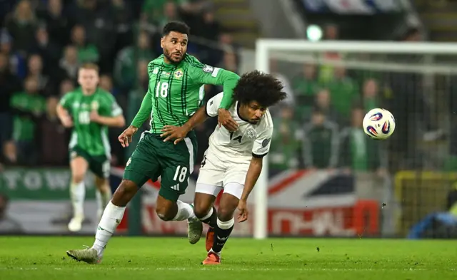 Karim Adeyemi of Germany is tackled by Jamie Reid of Northern Ireland during the FIFA World Cup 2026 qualifier match between Northern Ireland and Germany