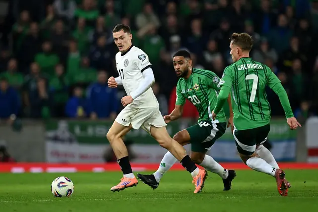 Florian Wirtz of Germany runs with the ball whilst under pressure from Brodie Spencer of Northern Ireland- during the FIFA World Cup 2026 qualifier