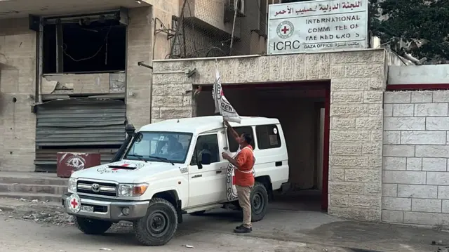 A Red Cross vehicle at an entrance to the Red Cross headquarters before the expected release of hostages held in Gaza