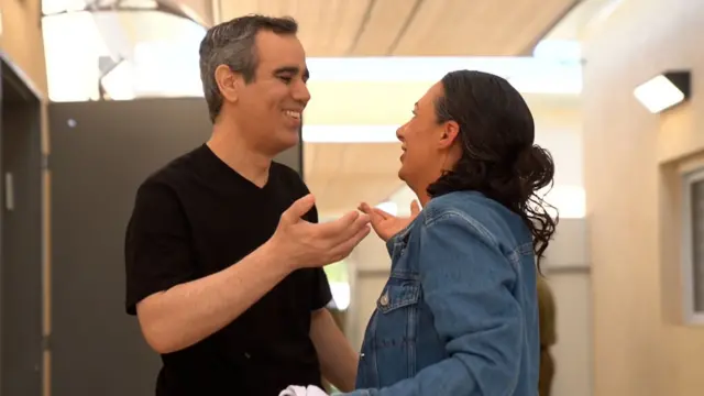 Omri smiling at his wife