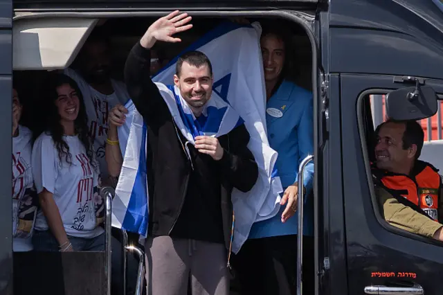 Former hostage Guy Gilboa-Dalal waves to supporters outside Beilinson Hospital in the Rabin Medical Centre