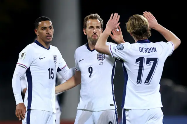 Harry Kane of England celebrates scoring his team's second goal with teammate Morgan Rogers and Anthony Gordon