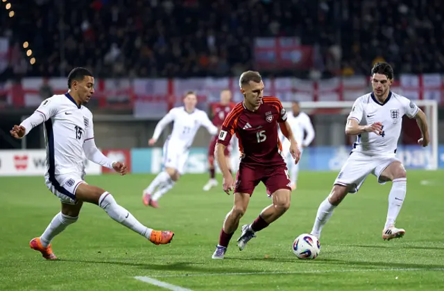 Dmitrijs Zelenkovs of Latvia, Morgan Rogers and Declan Rice of England battle for possession