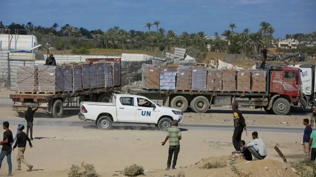 Aid trucks accompanied by UN vehicle