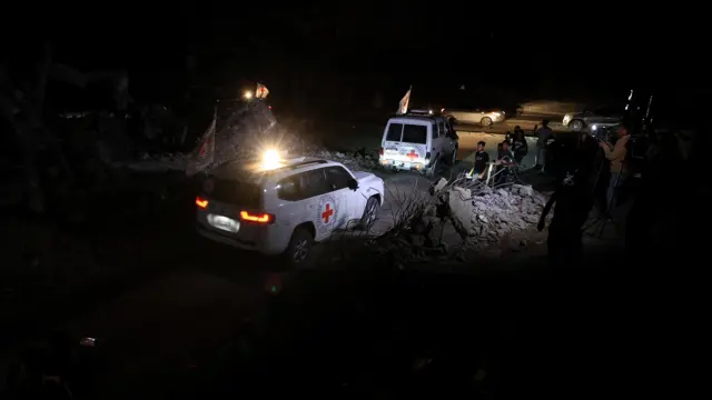 Red Cross vehicles leave the scene