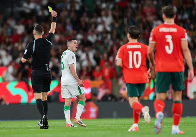 Josh Cullen is shown a yellow card in the Republic of Ireland's defeat in Lisbon against Portugal.