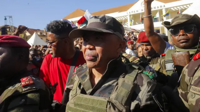 Colonel Michael Randrianirina arrives with members of the military to join protesters gathered outside the town hall on Independence Avenue during a nationwide youth-led demonstration against frequent power outages and water shortages, in Antananarivo, Madagascar, October 14, 2025