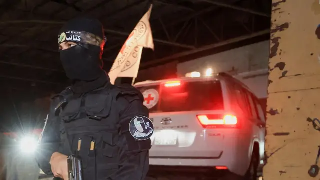 A militant in front of a vehicle