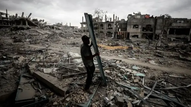 Members of the Palestinian Qayed family, who were forced to leave their homes during the Israeli attacks on Gaza City and returned home after the ceasefire, are cleaning their damaged home in the Sabra neighborhood of southern Gaza City,