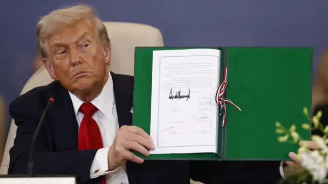 Donald Trump holds signed peace deal