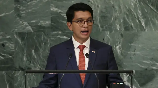 Andry Rajoelina talks into two microphones at a lectern