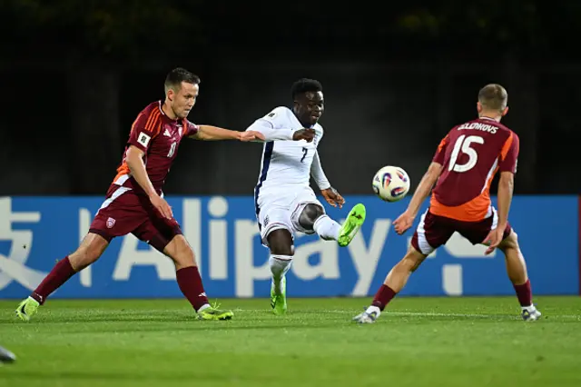 Bukayo Saka of England crosses the ball whilst under pressure