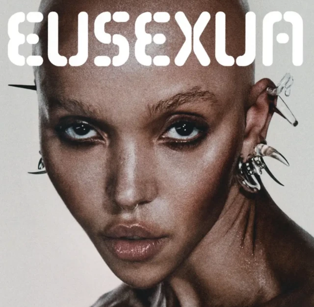 FKA twigs album cover, a close up of her face looking into the camera
