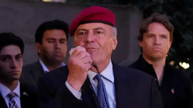 Curtis Sliwa, the Republican candidate for New York City mayor, wearing a red beret and blue tie, speaks at a rally