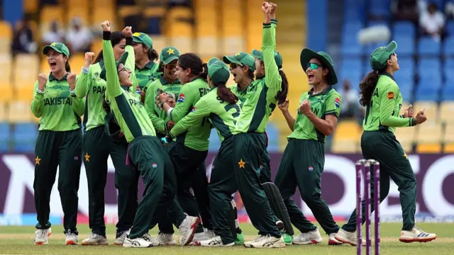 Fatima Sana of Pakistan celebrates with teammates after taking the wicket of Heather Knight of England