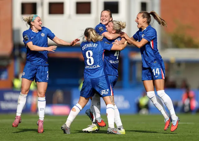 Chelsea players celebrate with Walsh after her goal