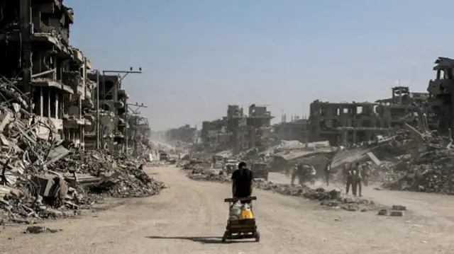 Residents walk through the widespread destruction in the Al-Katiba area and Street 5 of Khan Yunis, in Gaza
