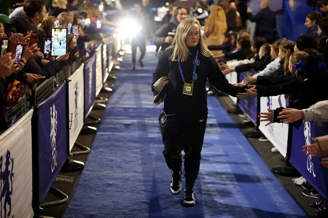 Erin Cuthbert of Chelsea interacts with the fans as she arrives
