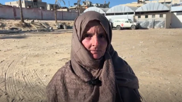Rasmieh Mohammad Khalil Qdeih stands outside Nasser hospital in Khan Younis, Gaza