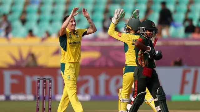 Megan Schutt of Australia celebrates with team mate Alyssa Healy after taking the wicket of Fargana Hoque of Bangladesh