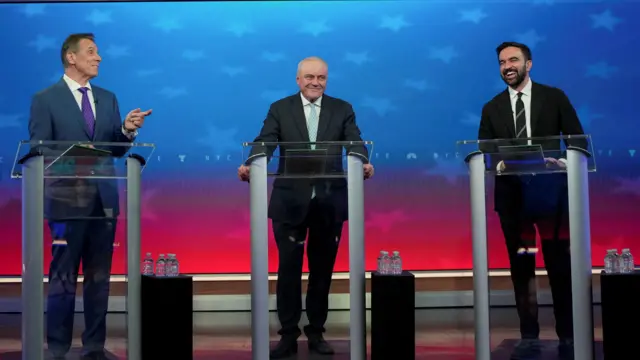 Independent candidate former New York Gov. Andrew Cuomo, Republican candidate Curtis Sliwa and Democratic candidate Zohran Mamdani participate in a mayoral debate, in New York, U.S. October 16, 2025.