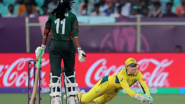 obhana Mostary of Bangladesh watches as she is dropped by wicket keeper Alyssa Healy of Australia during the ICC Women's Cricket World Cup India 2025