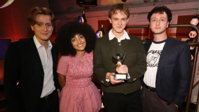 The band English Teacher posing with their award after winning the 2024 Mercury Prize