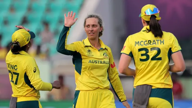 : Ash Gardner of Australia celebrates with team mates Alana King and Tahlia McGrath after taking the wicket of Sharmin Akter Supta