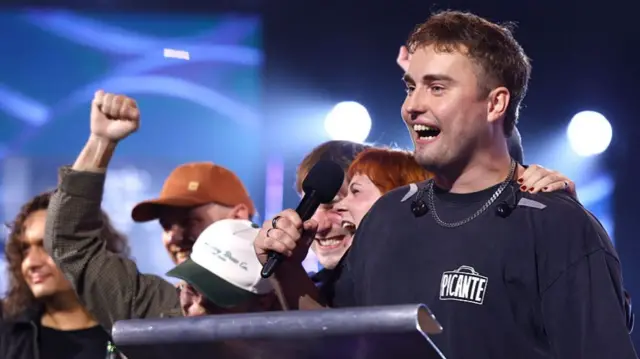 Fender stood with a mic on stage