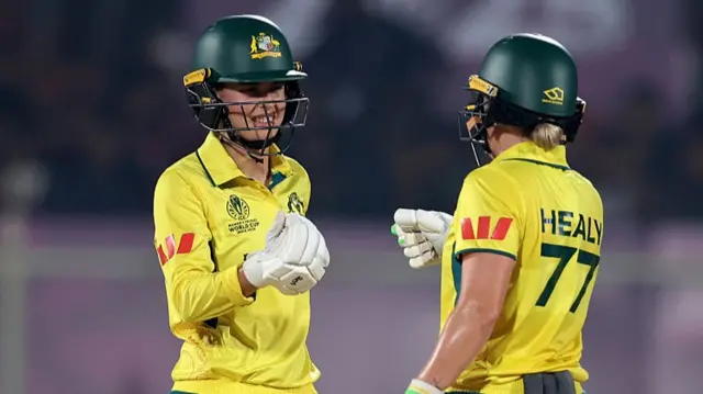 Phoebe Litchfield of Australia (L) fist bumps team mate Alyssa Healy
