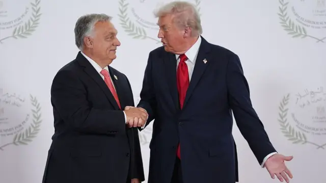 U.S. President Donald Trump (R) greets Hungary's Prime Minister Viktor Orban during a summit of European and Middle Eastern leaders on October 13, 2025